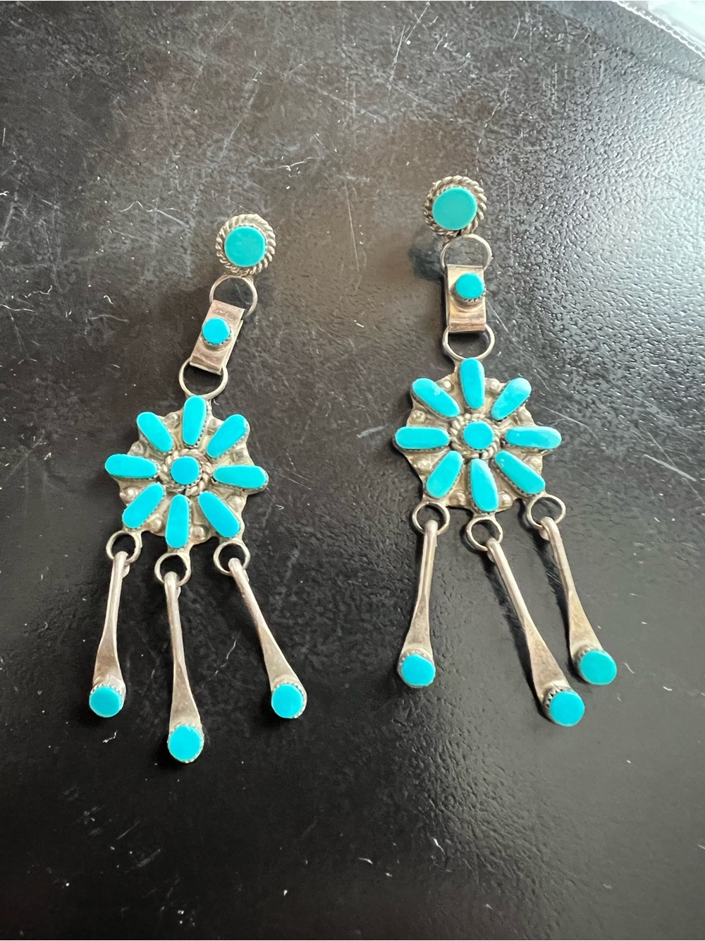 Traditional Zuni style sterling silver dangle needle point turquoise stones.